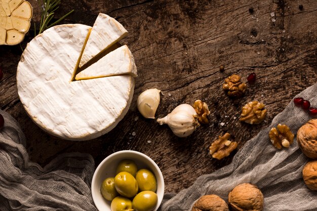 Top view composition of different delicacies on wooden table
