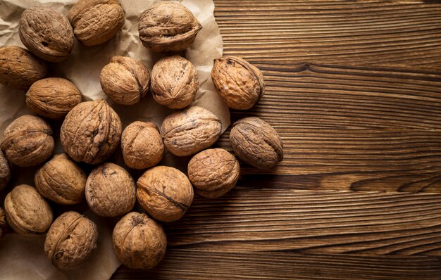 Top view composition of fresh autumnal nuts with copy space