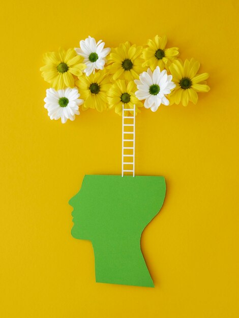 Top view composition of optimism concept with flowers