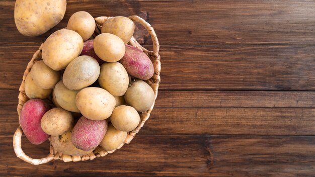 Top view composition of raw potatoes with copy space