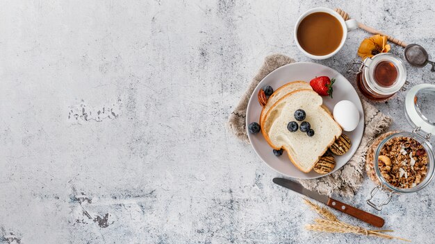 Top view composition of tasty breakfast goodies with copy space