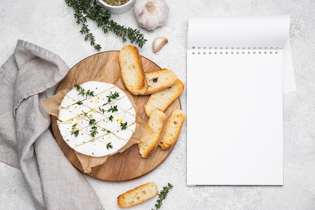 Top view composition with delicious local food meal with empty notepad