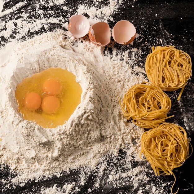 Top view composition with eggs and flour