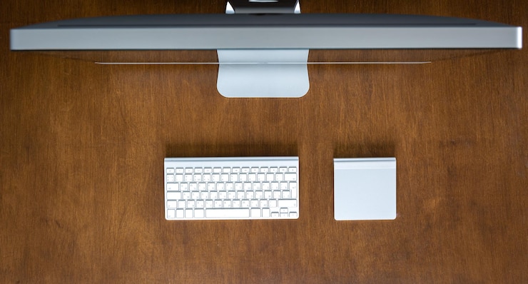 Free Photo top view computer on a wooden table work desk