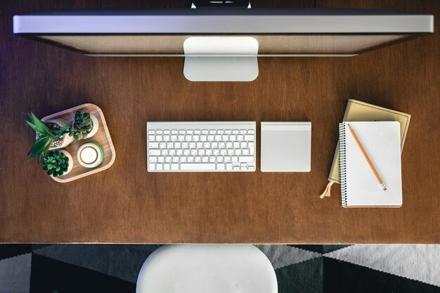 Top view computer on a wooden table work desk