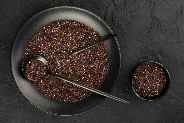 Top view of condiments in bowls with spoons