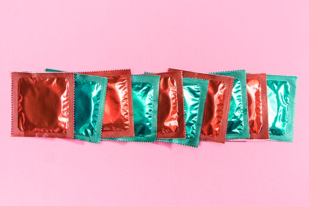 Top view condoms in red and green wrappers