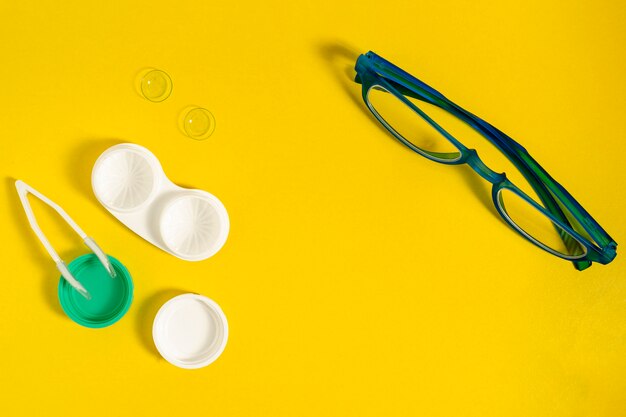 Top view of contact lenses with case and glasses