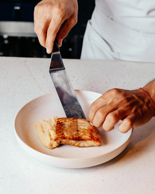 Top View Cook Preparing Meal Inside White Plate in Kitchen