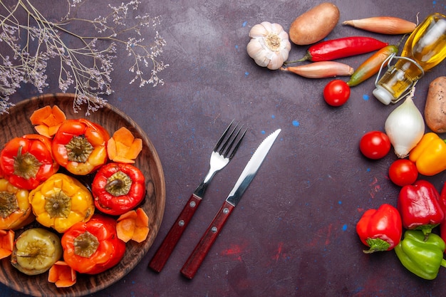 Top view cooked bell-peppers with fresh vegetables on the dark-grey surface meal vegetables meat dolma food