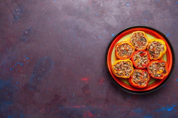 Top view cooked bell-peppers with ground meat on dark-grey background food beef dolma vegetable meal