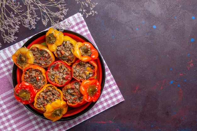 Top view cooked bell-peppers with ground meat on a grey desk food beef dolma vegetables meal