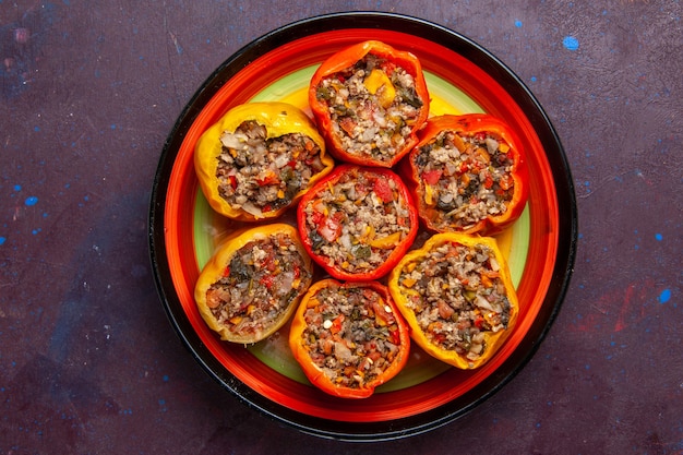 Top view cooked bell-peppers with ground meat on grey surface food beef dolma vegetables meal