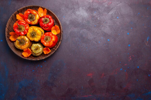 Top view cooked bell-peppers with ground meat inside on a grey background meal vegetables meat dolma food