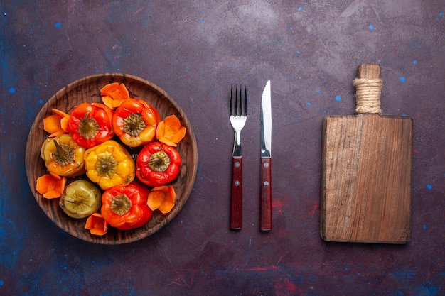 Top view cooked bell-peppers with ground meat inside on grey surface meal food meat vegetables cooking