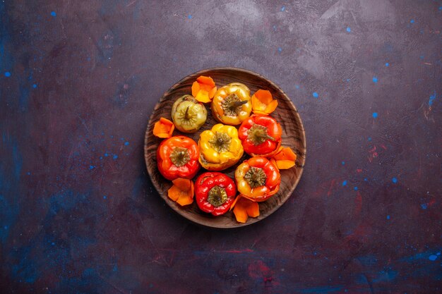 Top view cooked bell-peppers with ground meat inside on grey surface meal vegetable meat dolma food