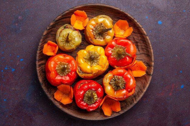 Top view cooked bell-peppers with ground meat inside on grey surface meal vegetables meat dolma food