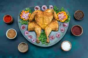 Free photo top view cooked chiken with onions and greens inside plate on dark-blue desk chicken meat bake oven dinner