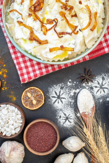 Top view cooked dough pieces with fried onions and different ingredients on a dark background dinner dish photo food oil meal cooking