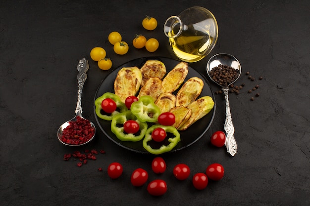 top view cooked eggplant along with fresh vegetables inside black plate on the dark background