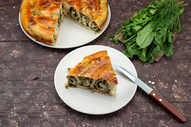 Top view cooked greens pastry round inside brown background desk meal food pastry lunch greens