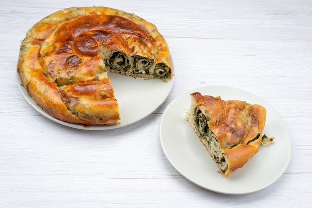 Top view cooked greens pastry round inside white plate desk meal food pastry lunch greens