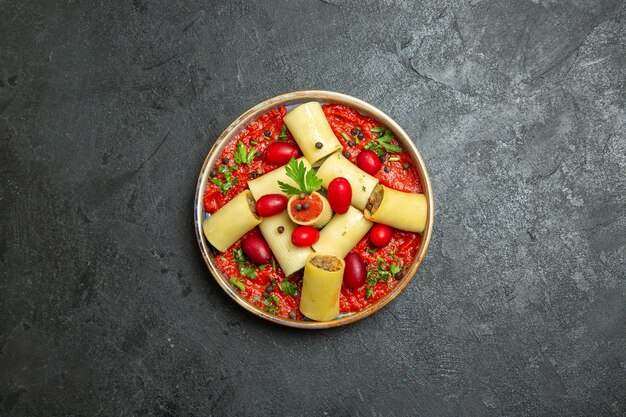 Top view cooked italian pasta delicious meal with meat and tomato sauce on grey background pasta dough meat dish food