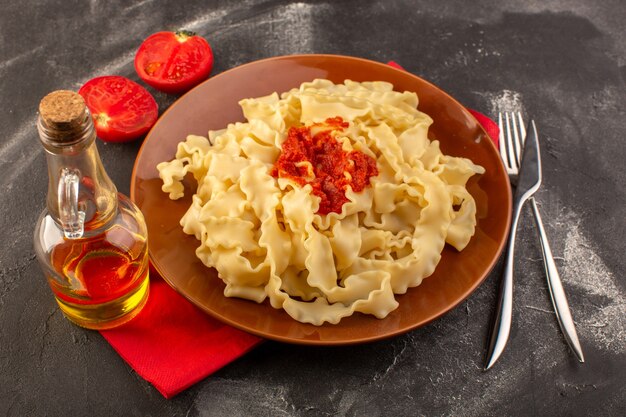 회색 테이블 음식 식사 이탈리아 파스타에 칼과 토마토 접시 안에 토마토 소스와 함께 이탈리아 파스타 요리 상위 뷰