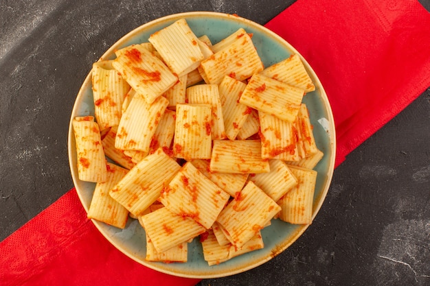 A top view cooked italian pasta with tomato sauce inside plate