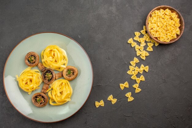 Top view cooked mushrooms with pasta on a dark table mushroom ripe wild meal