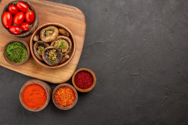 Top view cooked mushrooms with seasonings on dark table food wild ripe