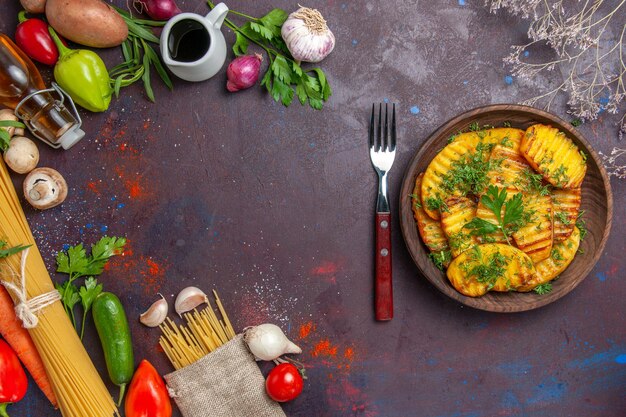 Top view cooked potatoes delicious dish with greens on dark surface cooking dish potato dinner meal food