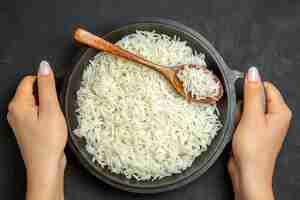 Free photo top view cooked rice inside pan on the dark surface meal food rice eastern dinner