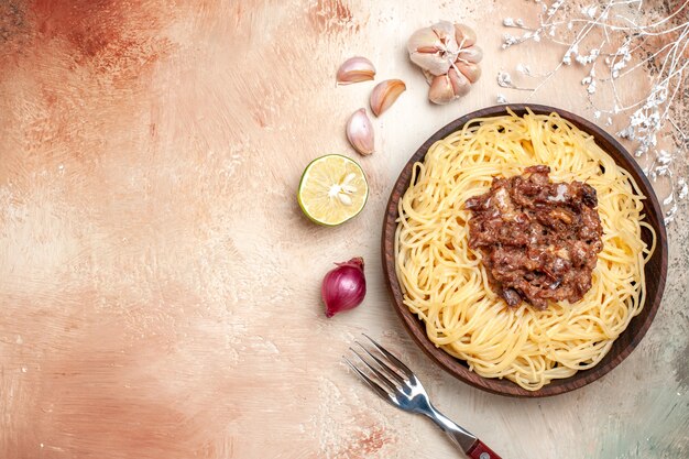 Top view cooked spaghetti with ground meat on light floor pasta meat dough dish meal