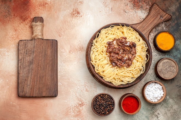 Top view cooked spaghetti with ground meat on a light table dish pasta meat
