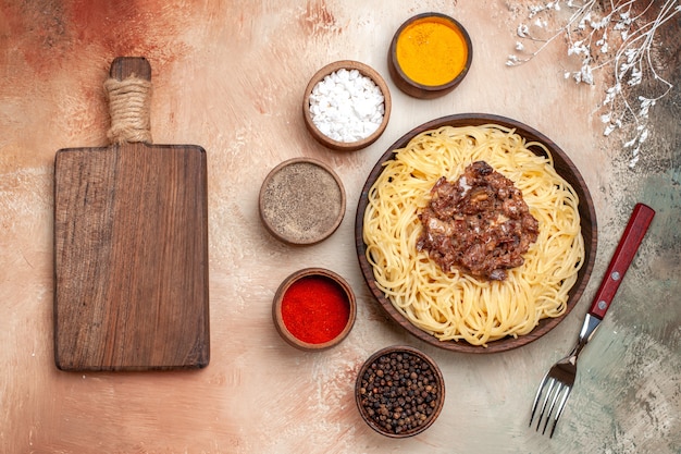 Top view cooked spaghetti with ground meat on light table pasta dough dish meal