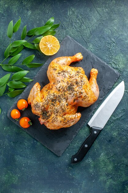 Top view cooked spiced chicken on a dark surface