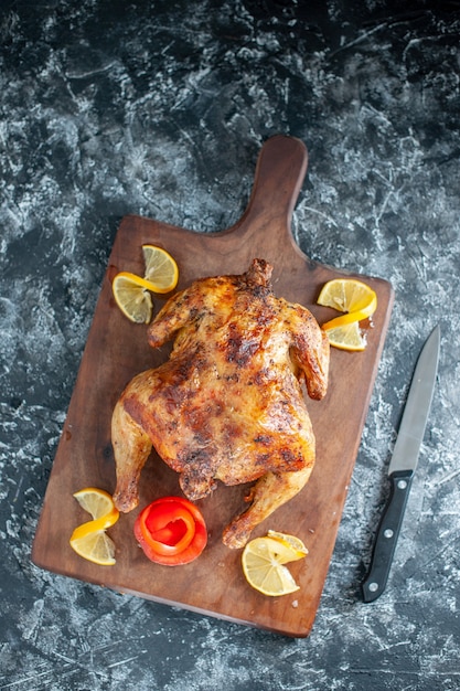 Top view cooked spiced chicken with lemon on light gray surface