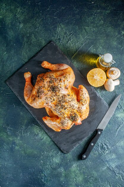 Top view cooked spiced chicken with oil on dark surface