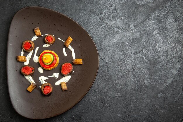 Top view of cooked squashes designed meal inside plate on a grey surface