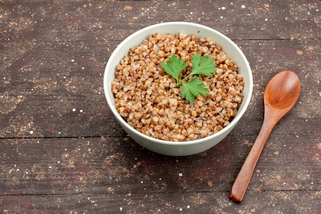 Free photo top view cooked tasty buckwheat inside plate on dark