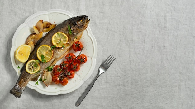 Free photo top view cooked trout still life