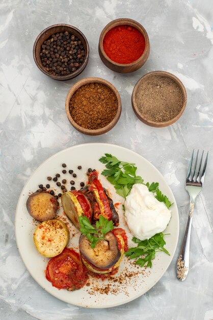 Top view cooked vegetable meal with seasonings on the bright background vegetable meal dish food