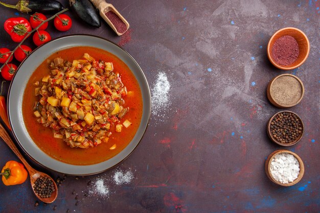 Top view cooked vegetables sliced with sauce and seasonings on a dark background meal food dinner soup sauce vegetable