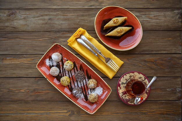 Top view of cookie balls and pakhlava served with tea