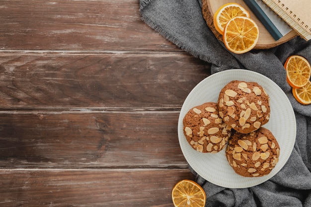 Top view cookie plates and dried lemon slices with copy-space