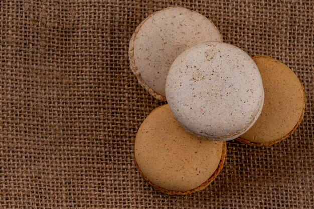 Top view of cookie sandwiches on sackcloth background with copy space