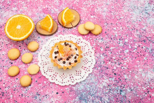 Top view cookies and cake with orange slices on the colored desk cookie biscuit fruit cake sweet