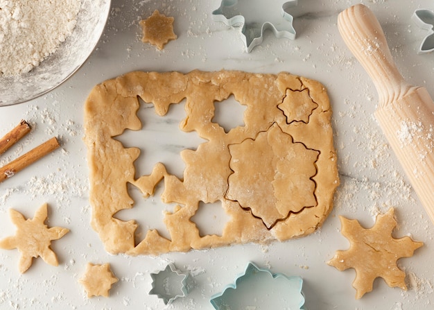 Top view of cookies dough in snowflakes shape