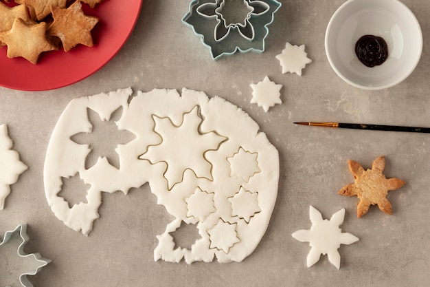 Top view of cookies dough in snowflakes shape